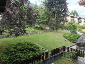an aerial view of a park with a fence at Mountain Haven Free parking in Temù