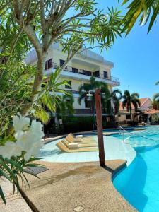 a resort with a swimming pool and a building at Sunville Hotel and Restaurant in Panglao Island +50 photos