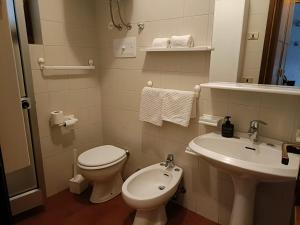 a bathroom with a toilet and a sink at Mountain Haven Free parking in Temù