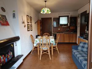 a dining room and kitchen with a table and chairs at Mountain Haven Free parking in Temù