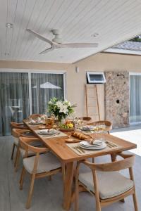 a wooden dining room table with chairs and a ceiling at Jungle Home in Koh Samui