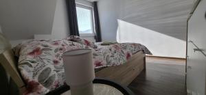 a bedroom with a bed with a flowered comforter at Apartmán STATION Vrútky centrum in Vrútky
