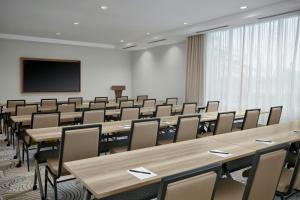 a conference room with tables and chairs and a screen at SpringHill Suites by Marriott Ventura Oxnard in Oxnard +26 photos