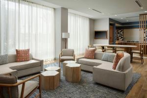 a living room with couches and chairs and a table at SpringHill Suites by Marriott Ventura Oxnard in Oxnard