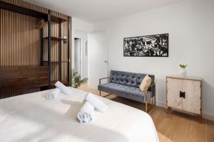 a bedroom with a bed and a couch at WonderStays Villa Lucía in Málaga +71 photos