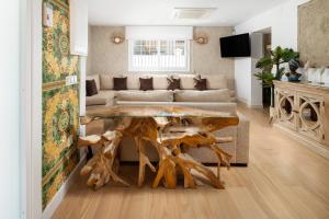 a living room with a table made out of tree branches at WonderStays Villa Lucía in Málaga