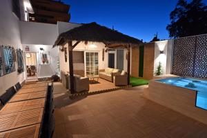 a backyard with a swimming pool and a house at WonderStays Villa Lucía in Málaga