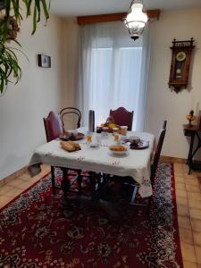 a table with food on it in a living room at Chambres Du Bois Des Hâtes in Saint-Avertin +12 photos