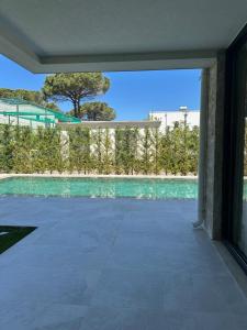 a view of a swimming pool from the inside of a house at Azure Pool Villa in Lalzit Bay