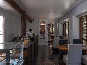 a restaurant with a bar and tables and chairs at PURE Hotel Lijiang in Lijiang
