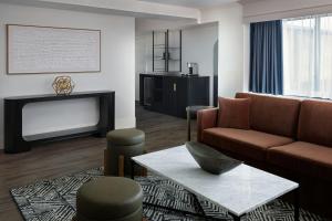 a living room with a couch and a television at Marriott Raleigh Durham Research Triangle Park in Durham