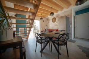 a kitchen and dining room with a table and chairs at Trémière et cabane in La Jarrie
