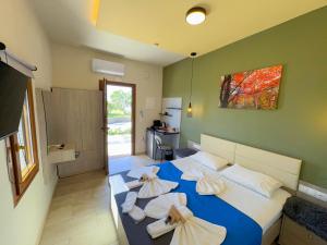 a bedroom with a blue bed with white pillows at Elafonisi Paradise with Parking, WiFi, - Walking Distance to the Beach in Elafonisi