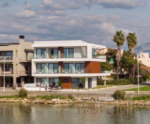 a large house by a body of water at The Grand Blue Boutique Hotel in Missolonghi