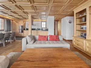 a living room with a couch and a table at Luxurious Flat with Jacuzzi Sauna in Schönried