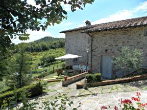 an external view of a stone house with a garden at Casale Mocali in Fattoria del Mulinaccio