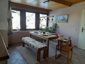 a dining room with a wooden table and chairs at Eichhörnchen, Ferienwohnung in Schneverdingen +7 photos