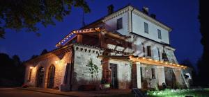 an old building with lights on it at night at Poggio Cortese in Todi