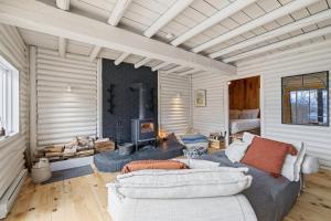a living room with a couch and a fireplace at Sauna Forest Escape & Relaxation - Chalet Orman in Brownsburg +37 photos