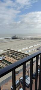 a view of a beach with a pier and the ocean at Zeezicht Studio Alisa in Blankenberge