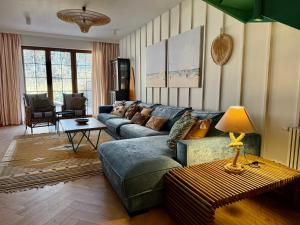 a living room with a couch and a table at Sea You Beach House in Rogowo