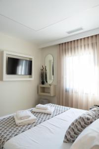 a bedroom with a bed with two towels on it at Antaia 2 in Nafplio