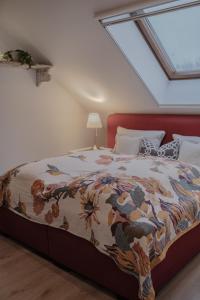 a bedroom with a large bed with a skylight at Landgut zur Mühle in Dorfen