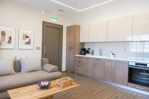 a living room with a couch and a kitchen at Antaia 2 in Nafplio