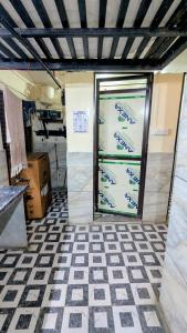 a garage door in a room with a checkered floor at KSHIPRA GUEST HOUSE in Ujjain