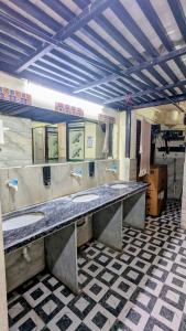 a public bathroom with two sinks in a room at KSHIPRA GUEST HOUSE in Ujjain