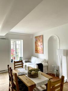 a living room with a table and a couch at Le Clos des Erables in Dijon