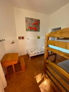 a room with a bunk bed and a desk and a bunk bed at Le Clos des Erables in Dijon
