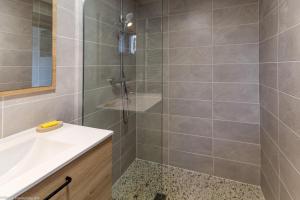 a bathroom with a shower and a sink at Le Clos des Erables in Dijon