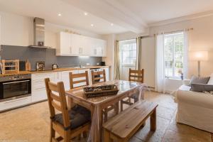 a kitchen and living room with a table and chairs at Le Clos des Erables in Dijon +10 photos
