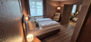 ein kleines Schlafzimmer mit einem Bett in einem Zimmer in der Unterkunft Hotel Mecklenburger Mühle Garni in Wismar