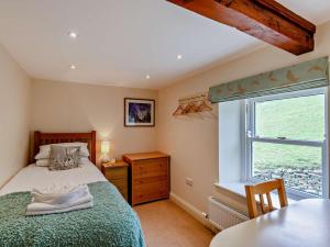 a bedroom with a bed and a window and a table at 4 Bed in Richmond oc-g0083 in Feetham