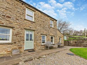 a brick house with a bench in front of it at 4 Bed in Richmond oc-g0083 in Feetham