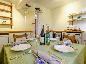 a table with plates and wine glasses on it at 2 Bed in Cupar oc-78228 in Ceres