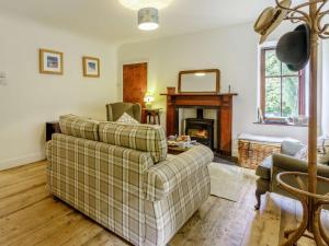 a living room with a couch and a fireplace at 2 Bed in Cupar oc-78228 in Ceres