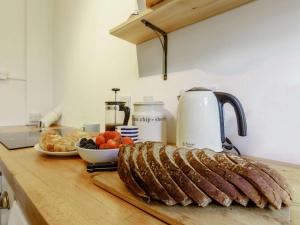 a loaf of meat on a counter with a plate of fruit at 2 Bed in Cupar oc-78228 in Ceres +11 photos