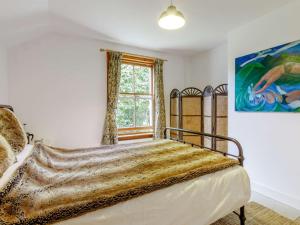 a bed in a bedroom with a painting on the wall at 2 Bed in Cupar oc-78228 in Ceres