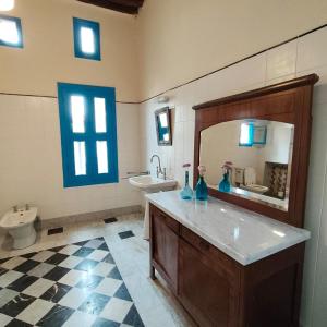 a bathroom with a sink and a toilet and a mirror at Boutique Hotel Beit el Nessim in El Mîna +64 photos