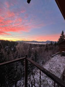 a view from a balcony at sunset at Квітуча Гора Double Room in Lazeshchyna +6 photos
