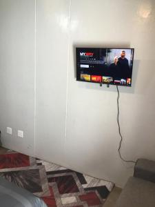 a television hanging on a wall in a room at Home at heart in Johannesburg