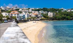 a view of a beach with buildings in the background at AQUAMARINE HOTEL Nagahama in Nagahama