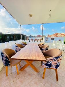 a wooden table and chairs on a roof at Hello Rafiki Hotel Stone town in Ngambo
