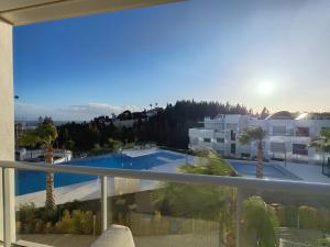 a balcony with a view of a swimming pool at Vitta Nature Spa - 3 bedrooms in Mijas Costa