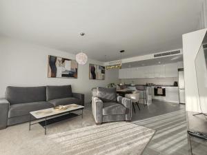 a living room with a couch and a table and a kitchen at Vitta Nature Spa - 3 bedrooms in Mijas Costa