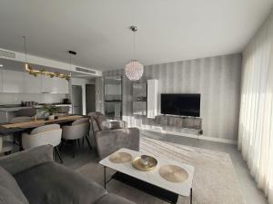 a living room with a couch and a table at Vitta Nature Spa - 3 bedrooms in Mijas Costa
