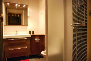 a bathroom with a sink and a toilet and a mirror at Karhunvartija 11 Visit Levi in Sirkka